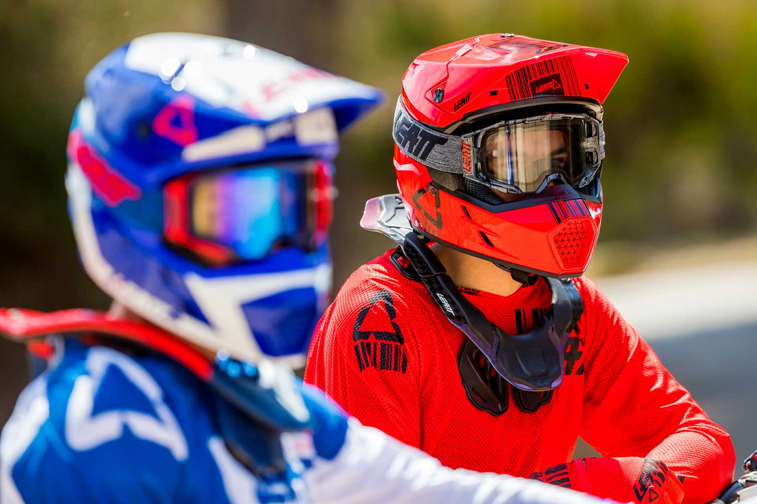 Two dirt bike riders wearing a leatt helmet, jersey, and goggles