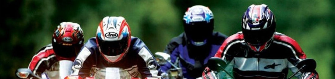 Riding a motorcycle in black leather jacket and silver road helmet about to go for a ride with a friend 