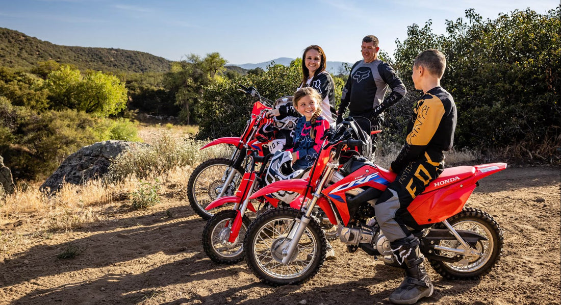 family our riding on their Honda dirt bikes 