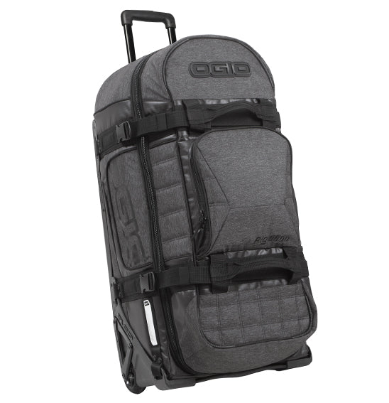 The Ogio RIG 9800 - Dark Static is a large, wheeled rolling duffel bag in black and gray with a telescoping handle. Featuring multiple compartments, adjustable straps, and padded sections for gear protection, this durable bag proudly displays the OGIO logo on the front and side.