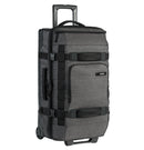 The OGIO ONU 26 Travel Bag in Dark Static features a retractable handle extended, multiple handles on the front and side, black straps for additional support, and several compartments. The OGIO logo is visible near the top. Its rugged TPU wheel set allows it to stand upright on its wheels.