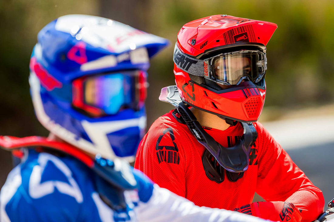 Two dirt bike riders wearing a leatt helmet, jersey, and goggles 