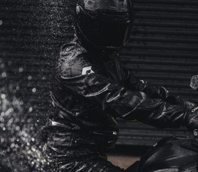 Motorcycle rider riding a Motorcycle wearing a black scott waterproof jacket
