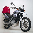The image features the Ventura EVO-12 Bike-Pack Kit for the BMW F 650 GS, Y (2000). It consists of a sleek black bike pack with zippers and a logo, an Evo-Rack for easy mounting, and an L-bracket with screws, displayed on a Top-Box Rack on a bike.