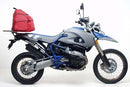 The Ventura EVO-12 Bike-Pack Kit for the BMW HP2 Enduro (06-10) features a sleek black and orange bag, versatile EVO-RACK, and durable black metal L-BRACKETS with screws. Its adjustable Pack-Rack design ensures a secure fit for adventurous journeys.