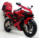 The EVO-12 Bike-Pack Kit for Honda CBR 600 RR 3, 4 (03-04) by Ventura includes an Adjustable Pack-Rack with a black bike pack featuring an orange stripe, a versatile black Evo-Rack attached to a bike, and L-brackets with screws labeled as "generic image.