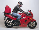 Image showcasing the Ventura EVO-12 Bike-Pack Kit for the Honda VFR 800 F1, W, X, Y (98-00), featuring a black pack with orange accents labeled "EVO-12 PACK," an "EVO-RACK" bike rack, and L-brackets with screws. This adjustable pack-rack is ideal for adventure enthusiasts.