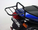 The image showcases Ventura's Honda VTR 250 (98-07) Bike-Pack Kit, featuring the versatile Pack-Rack. It includes a sleek black EVO-12 Pack securely fastened with the robust EVO-Rack on a bike, plus an L-Bracket set with all necessary screws and bolts for easy assembly.