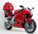 The image showcases a sleek black storage bag labeled "EVO-12 PACK" and the sturdy "EVO-RACK" bike rack, complemented by an L-bracket with screws, all set against a crisp white background. Compatible with the Hyosung GT 650R (06-09) from Ventura.