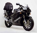 Image showcasing the Ventura EVO-12 bike-pack kit. Top left: black EVO-12 pack with reflective stripe. Top right: Adjustable Evo-Rack on a Kawasaki ZXR 250 A1-A2 motorcycle. Bottom: L-Bracket with screws for installation, labeled as a generic image.