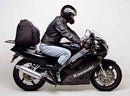 Image showcasing the Ventura EVO-12 bike-pack kit. Top left: black EVO-12 pack with reflective stripe. Top right: Adjustable Evo-Rack on a Kawasaki ZXR 250 A1-A2 motorcycle. Bottom: L-Bracket with screws for installation, labeled as a generic image.