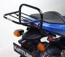 The image showcases a Ventura Kawasaki Z 750 (04-05) Bike-Pack Kit featuring a black EVO-12 pack and an adjustable EVO-Rack attached to a motorcycle. It also includes an L-bracket with screws and fittings, highlighting the kit's versatile setup.