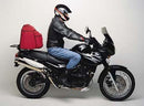Image shows Ventura EVO-12 Bike-Pack Kit for Triumph Tiger 900 X, Y (99-00), including an EVO-12 pack (black bag), Evo-Rack Top-Box Rack on a bike, and L-Brackets with screws. Labeled "Generic Image.