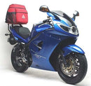 Ventura EVO-12 Bike-Pack Kit for Triumph Sprint ST 1050 (05-10), includes black EVO-12 pack, Evo-Rack (Top-Box Rack) mounted on bike, and L-Brackets with screws. Generic image shown.