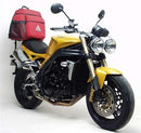 Image showing the Ventura EVO-12 Bike-Pack Kit for Triumph Speed Triple 1050 (05-10) with three labeled components: the black EVO-12 pack, Evo-Rack mounted on a bike, and L-Bracket with screws.