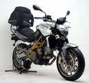 Image showing three components of the Ventura EVO-12 Bike-Pack Kit for Aprilia Shiver 750 (08-09): an EVO-12 Pack (black bag), an Evo-Rack Top-Box Rack on a bike, and an L-Bracket with screws.