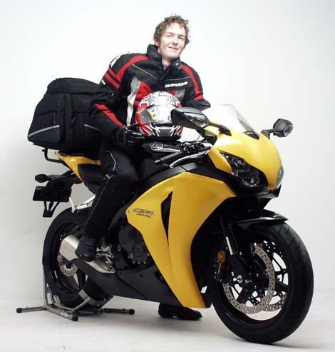 The EVO-12 Bike-Pack Kit for the Honda CBR 1000 RR Fireblade (08-11) by Ventura includes a sleek black EVO-12 pack, a durable Evo-Rack, and an L-Bracket with screws. Displayed on a motorcycle, it highlights the versatile Evo-Rack and shows the L-Bracket separately for clarity.