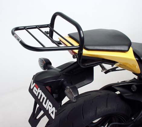 The EVO-12 Bike-Pack Kit for the Honda CBR 1000 RR Fireblade (08-11) by Ventura includes a sleek black EVO-12 pack, a durable Evo-Rack, and an L-Bracket with screws. Displayed on a motorcycle, it highlights the versatile Evo-Rack and shows the L-Bracket separately for clarity.