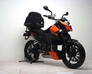 The image features a Ventura EVO-12 Bike-Pack Kit on a KTM 690 Duke (2008), including the sleek black EVO-12 Pack with an orange stripe. It also displays the Adjustable Pack-Rack, EVO-Rack, and L-bracket with screws, completing this versatile setup.