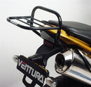 Three labeled items: Ventura EVO-12 bike-pack (black zippered bag), Adjustable Pack-Rack (black rear bike rack), and L-bracket with screws for Triumph Tiger 1050 (07-12). Text: "EVO-12 Bike-Pack Kit.
