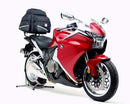 Image showing a Ventura EVO-12 Bike-Pack Kit for Honda VFR 1200F (10-16) with a black "EVO-12 PACK" bag, metal Evo-Rack rear rack, and black L-brackets with hardware labeled "L-BRACKET Generic Image." Compatible with Top-Box Rack setups.