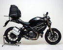 The Ventura EVO-12 Bike-Pack Kit for Ducati 1100 Monster EVO (11-12) includes a black EVO-12 pack, a black Adjustable Pack-Rack (EVO-Rack) mounted on the motorcycle, and an image of L-brackets with screws. Each item is clearly labeled.