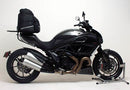 The image showcases the Ventura Ducati 1200 Diavel (11-12) Bike-Pack Kit, featuring an EVO-12 pack, a Pack-Rack for enhanced adventure readiness, and an L-bracket with screws. The sleek black pack has a zip closure for secure storage.