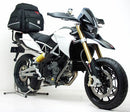 The Ventura Pack Kit for the Aprilia Dorsoduro 1200 (11-15) includes a sleek black EVO-12 PAC bike pack, an Evo-Rack metal bike rack, and a set of L-brackets with screws, all depicted in a generic image.