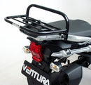 The Ventura Bike-Pack Kit for Triumph Tiger Explorer 1200 (12-18) includes three labeled parts: a black EVO-12 Pack, a black metal Adjustable Pack-Rack mounted on the bike, and a generic L-Bracket with hardware.