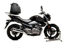 The Ventura EVO-12 Bike-Pack Kit for Suzuki GW 250 Inazuma (13-16) includes a black EVO-12 pack, an Evo-Rack mounted on a motorcycle, and an L-bracket with screws; all components are clearly labeled for easy assembly.