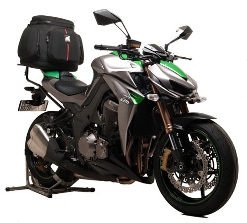 The image features the Ventura EVO-12 Bike-Pack Kit for the Kawasaki Z 1000 ABS/Ninja (14 ->) with a black and orange EVO-12 bag. It highlights the mounted Evo-Rack and accompanying L-Bracket with screws, showcasing seamless integration for your biking adventures.