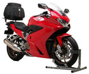 The Honda VFR 800FE (14-18) Bike-Pack Kit by Ventura is showcased with an Evo-Rack attached to a motorcycle, featuring the EVO-12 pack, a generic L-bracket, screws, and accessories, highlighting its versatility as an Adjustable Pack-Rack solution.