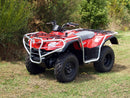 A Ventura Suzuki ATV LT-F 400F King Quad (08->), featuring four wheels, black tires, silver bull-bars, and protective bars, is parked on grass among green bushes and trees.