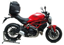 The Ventura EVO-12 Bike-Pack Kit for the Ducati 659 Monster (2019) includes a black EVO-12 rear pack, sturdy Evo-Rack, L-Bracket with screws, and an adjustable Pack-Rack—each part clearly labeled with its name.