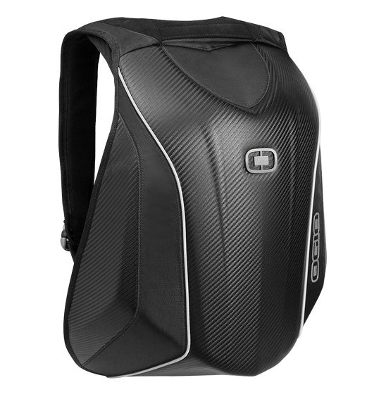 An Ogio MACH 5 Motorcycle Backpack - Stealth is open, revealing various compartments filled with items. The main compartment contains a helmet and a laptop, while smaller pockets hold a tablet and other accessories. Its interior has orange and black sections for organized storage, showcasing No Drag Technology.