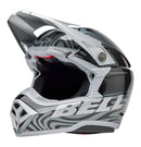 The Bell MOTO-10 SPHERICAL Cortex Gloss Silver/Grey helmet showcases a sleek, modern motocross design with a gray and black swirling pattern. It features angular lines, a visor peak, and incorporates MIPS technology for enhanced safety. The brand name "BELL" is prominently displayed on the side.