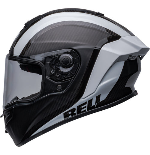 Side view of the Bell RACE STAR DLX FLEX Tantrum 2 Black/White helmet with a clear visor. The helmet boasts a sleek design with aerodynamic contours, Velocity Flow Ventilation, and a textured pattern on the top and sides. A Carbon Fiber Shell ensures durability, while the BELL logo is prominently displayed.