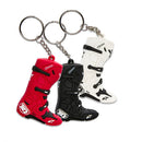 The ALPINESTARS Tech-10 Boot Key Fob Pack includes three detailed polyurethane keychains shaped like motorcycle boots in red, black, and white. Each limited edition piece features logos and metal rings for keys.
