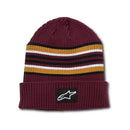 The Bolted Cuff Beanie Maroon by ALPINESTARS features a ribbed texture with black, white, and gold stripes. Its cuff displays a woven logo patch with a white star.