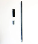 A threaded metal rod from the Rabaconda - 15mm Spindle Kit for Street Bike Tyre Changer lies on a white surface next to a small metal cylinder and a larger black wheel hub adapter.
