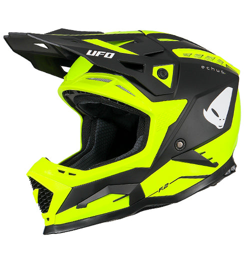 The UFO Echus Helmet in neon yellow and black features angular geometric designs, an alien logo near the back, and "UFO" branding. ECE 22.06 certified, it ensures top-notch safety for off-road adventures with its visor-equipped design.