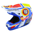 The SE5 ECE Composite Helmet Drop in White by Troy Lee Designs features bold red, blue, yellow, black, and white graphics, "Troy Lee Designs" text on the front and side, an open face design, multiple air vents, visor, and lightweight composite construction.