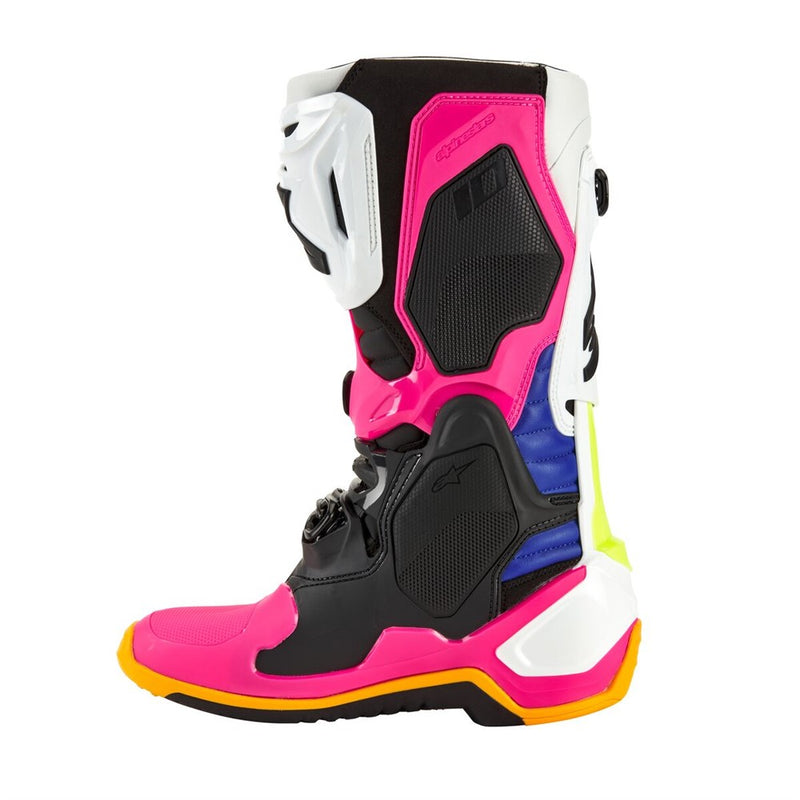 Introducing ALPINESTARS' Tech-10 MX Boots Coast LE with a striking design: one boot is blue with white and black accents, the other is pink with black and white. Both feature orange soles, dynamic heel compression protectors, distinctive buckles, and protective elements.