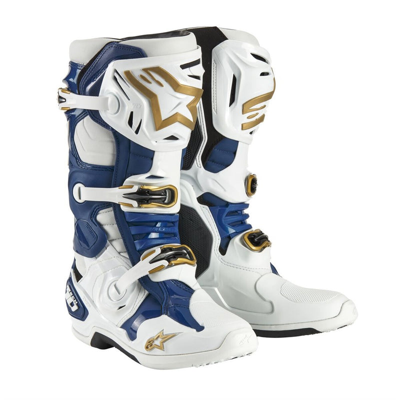 A pair of ALPINESTARS Tech-10 MX Boots Tropical in a striking white, blue, and gold color scheme. They include Dynamic Heel Compression Protector panels, adjustable buckles, and a rugged design for enhanced safety and performance.