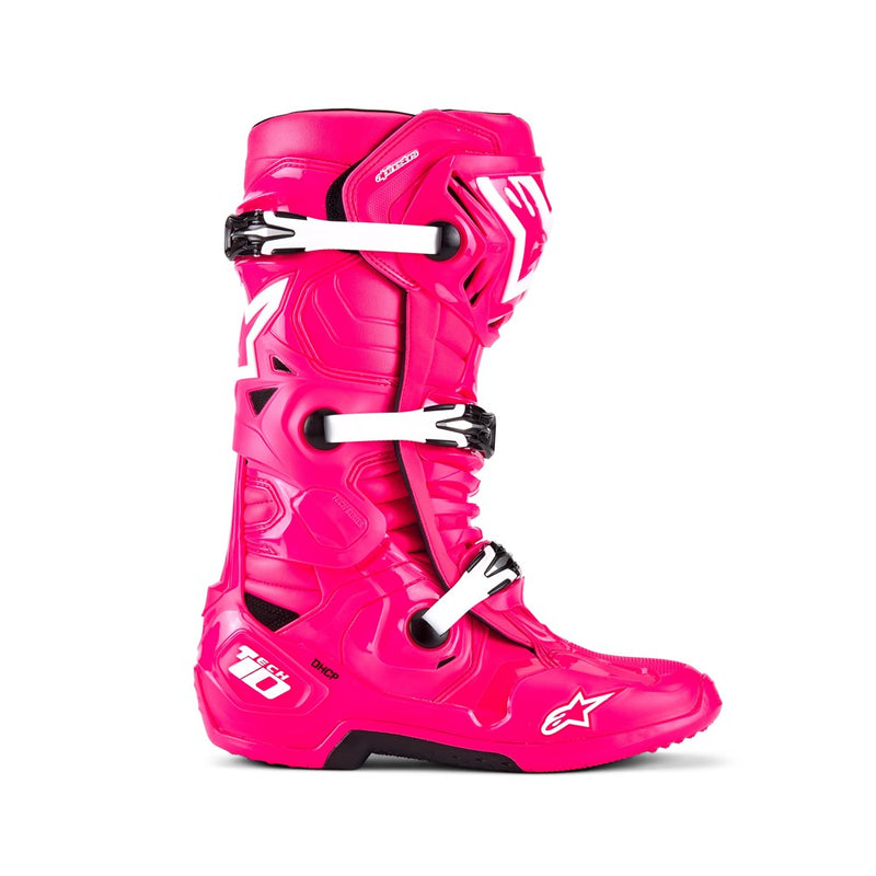 The bright pink Tech-10 MX Boots by Crown Kiwi Enterprises Limited feature black accents, Dynamic Heel Compression Protector, sturdy grip soles, and adjustable straps for a secure fit. The design shows off brand logos and highlights the front and side views.