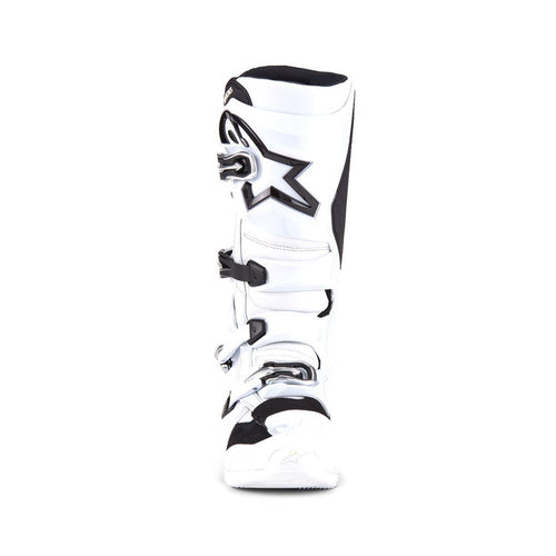 The ALPINESTARS Tech-7 MX Boots in white/black offer adjustable straps and protective features, designed for motocross or off-road use. They feature a sleek, sturdy design, impact resistance, and prominent branding on the top section.