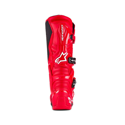 Tech-7 MX Boots Bright Red by Crown Kiwi Enterprises Limited feature white branding, adjustable buckles, and a high-grip sole. They're designed for off-road racing and prioritize performance and impact resistance for durability and safety on tough terrains.