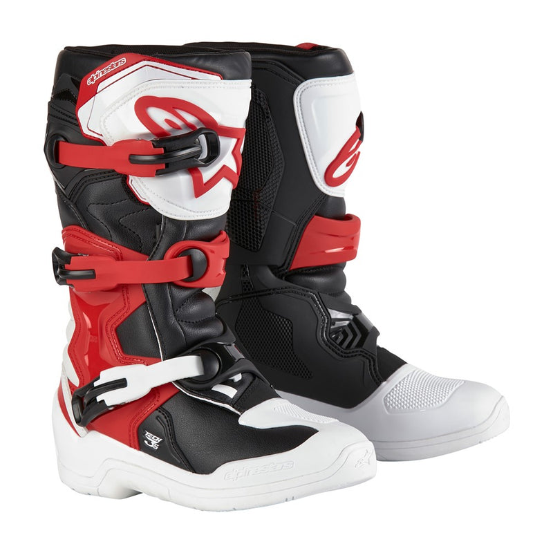 The Tech-3S Youth MX Boots by Crown Kiwi Enterprises Limited are perfect for junior riders, featuring one black boot with red and white accents and a white boot with red and black accents. Crafted from lightweight microfiber, they come with robust buckles and sturdy soles ideal for off-road biking.