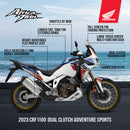 A motorcyclist wearing protective gear performs a wheelie on a Honda Africa Twin CRF1100, kicking up dust against a rugged, mountainous landscape with cloudy skies. The scene captures the dynamic motion and thrill of off-road bike riding in a remote, natural setting with the reliable performance of Honda.