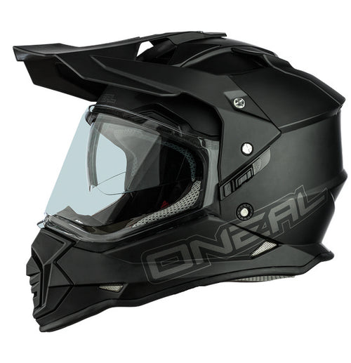 The O'Neal SIERRA Helmet R V.23 in flat black features a matte finish and angular, geometric design details on top; "ONEAL" branding is near the visor front, making it ideal for adventure bike riders.